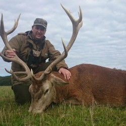 Mark Howard, Director of Deer Stalking in England Ltd. with a red stag.
